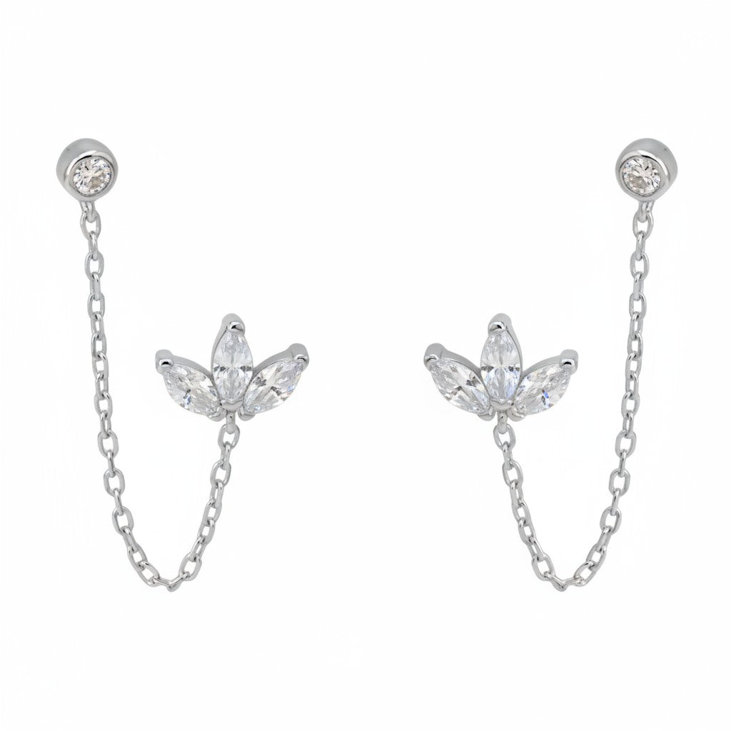 Yamor Jewelry Polo Exchange silver earrings with clear cubic zirconia in a lotus design, connected by a gold chain.