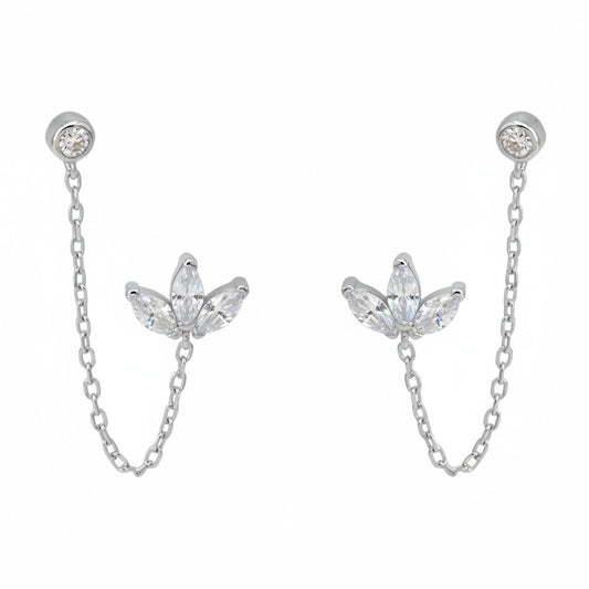 Yamor Jewelry Polo Exchange silver earrings with clear cubic zirconia in a lotus design, connected by a gold chain.